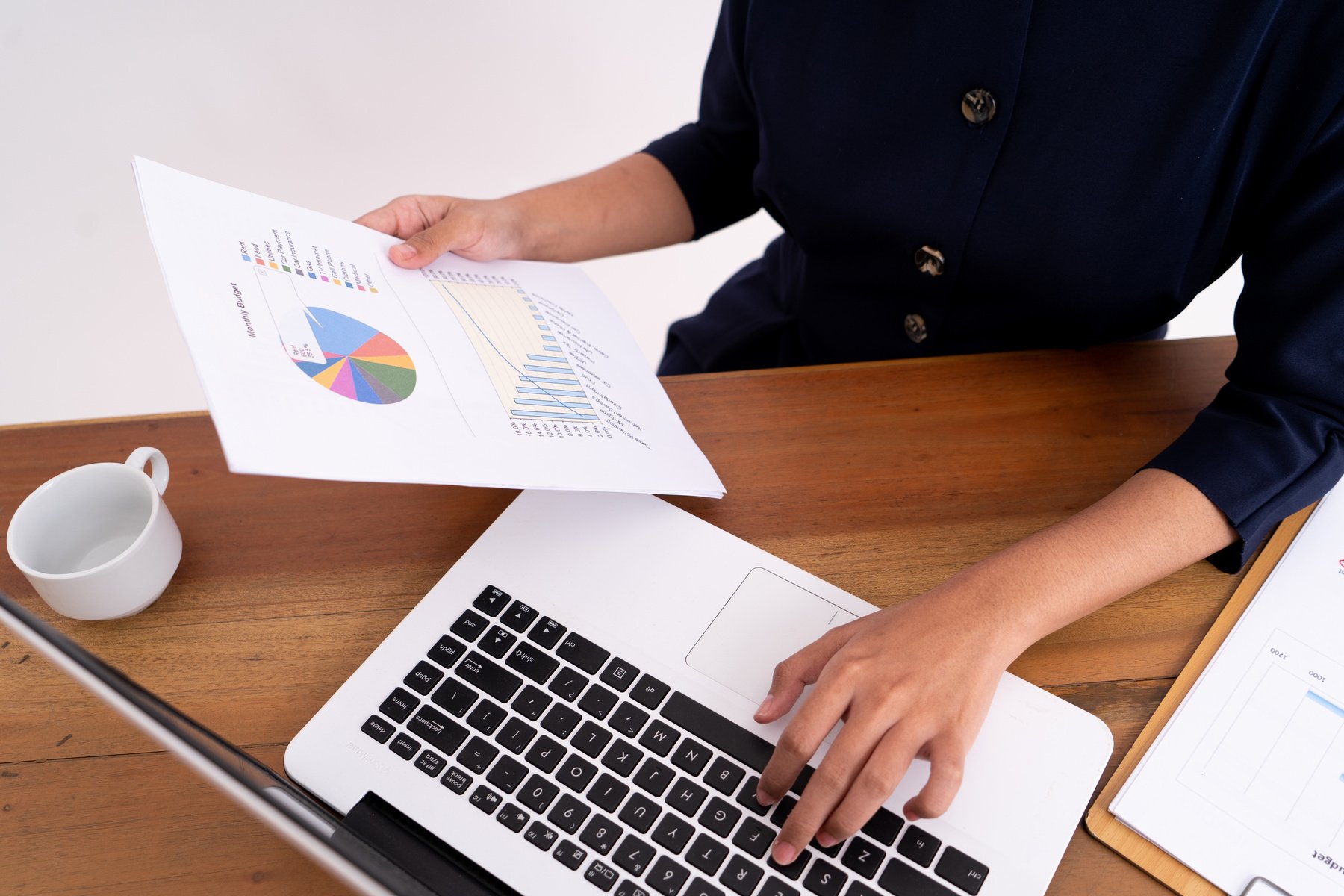 Close up Business Woman Calculating Her Business Profits and Working on a Laptop.